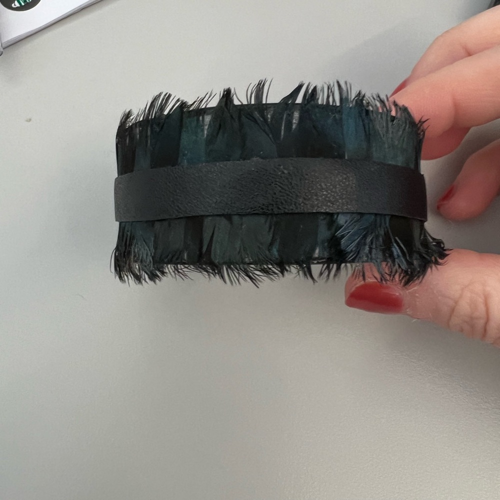 S Carter designs feather cuff. Worn once and comes with jewelry bag